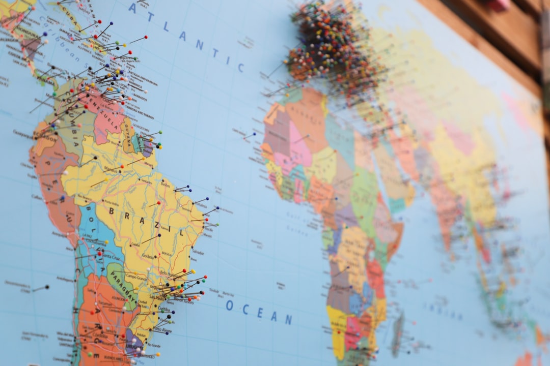 A world map covered in pins